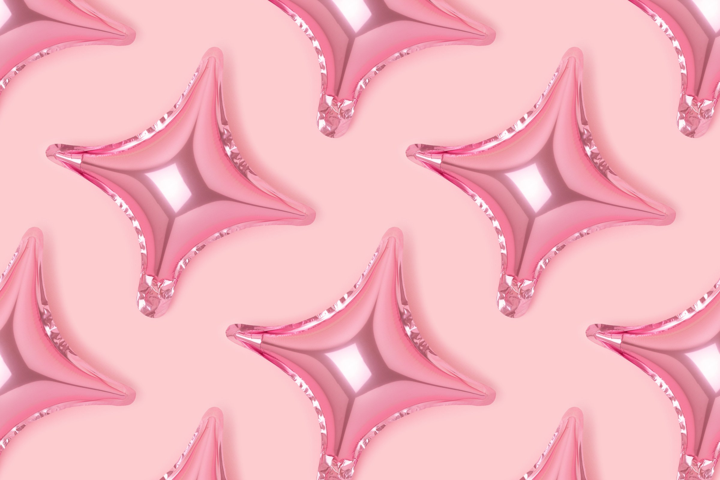 Repetitive pattern made of inflatable star balloons on a pink background.